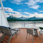 OV, Ovation of the Seas, balcony on Grand Loft Suite, clouds, lounge chairs, cabin, stateroom, sea view of Alaska mountains and glaciers, (comp image with stock photo from Shutterstock), 

NOTE: This is a composite photo made to represent Ovation of the Seas in Alaska. When using this image, please include this disclaimer:
 
"This image is an artistic rendering of Ovation of the Seas. Features vary by ship."